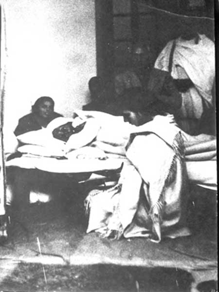 Gandhiji lying on the bed during his last fast at Birla House in New Delhi. He detctecting something Smt. Sushila Nayar who was sitting beside his bed.jpg